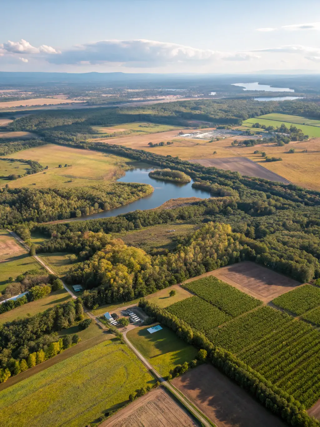 An aerial view of various land plot sizes available at Harmoni Horizon Valley, highlighting the spaciousness and potential for customization, with mountains in the background.
